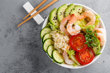 Hawaiian poke bowl with shrimps, rice and vegetables, healthy Buddha bowl with prawns, rice,...