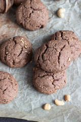 Delicious chocolate cookies with nuts on dark old concrete table. Copy space.