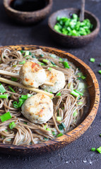 Soba noodles served with chicken meatballs and green onion. Buckwheat noodles. Gluten free. Asian food. Copy space.