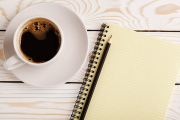 Business still life concept with office stuff on table. Business pocket planner and pen ready to note an appointment. Education, working or planning concept. Office desk with open paper notebook, pen