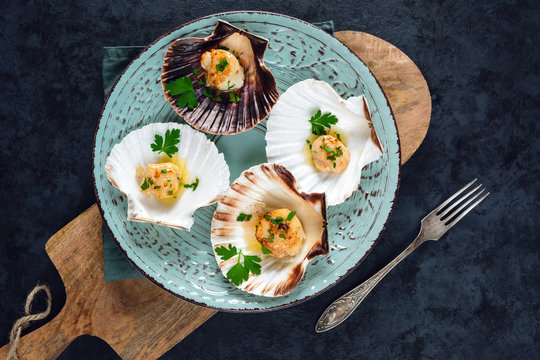 Seared scallops shell with butter, garlic and parsley.