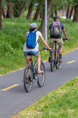 Fototapeta premium Adult couple biking together on the bike road in Hungary