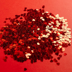  Small foil hearts on a red background