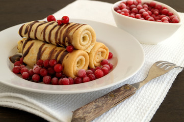 pancakes twisted with berries and chocolate sauce