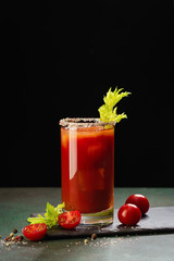 Bloody Mary cocktail. Alcoholic drink and ingredients on dark green background, Copy space