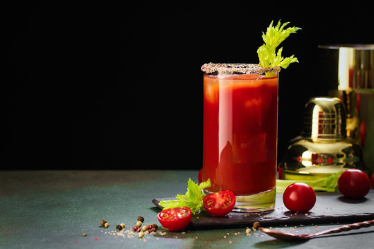 Bloody Mary cocktail. Alcoholic drink and ingredients on dark green background, Copy space