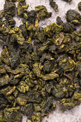 Fototapeta na wymiar Green Chinese oolong tea. Close-up. Stone background