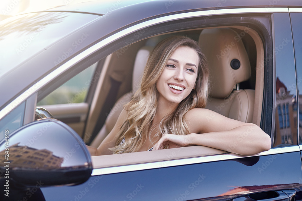 Poster woman sitting in the car and looking away