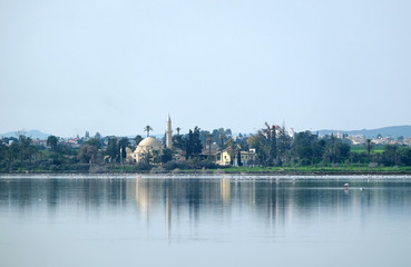 Naklejka premium Landscape Hala Sultan Tekke Mosque on the coast of Salt Lake calm water in Larnaca Cyprus