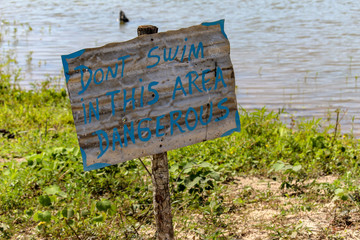 Warning sign don't swim in this area handmade sign photography