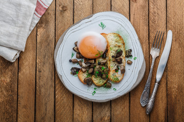 Soft-boiled goose egg with wild mushrooms and bread, copy space