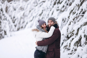 Young couple in love outdoor snowy winter