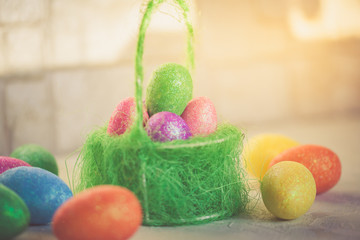 Easter scene with painted eggs in a basket, vertical image