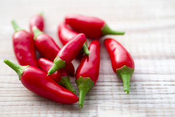 Red chili peppers on wooden background