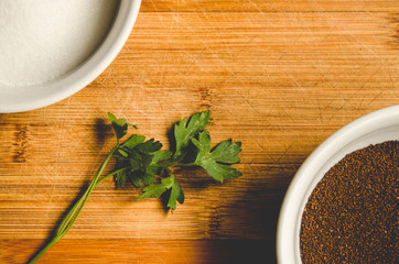 Overhead view of two bowls with sugar and coffee grounds
