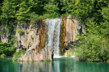 Fototapeta na wymiar The beautiful view of waterfalls in Plitvice lakes . The water is clear and turquoise.