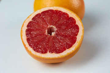 Line of sliced red grapefruit flat lay and top view. Macro photo of citrus fruits isolated on white black 