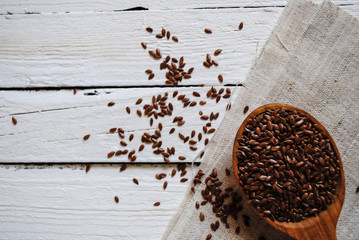 Flax in a wooden spoon on a white background
