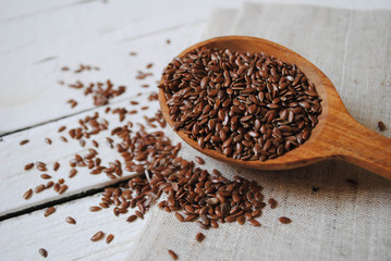 Flax in a wooden spoon on a white background