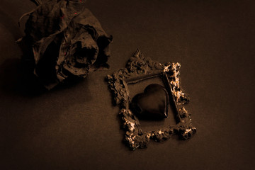 Black glass heart and black rose. Metal head, punk, emo lovers background.