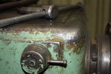 Professional lathe machine in a workshop. Part of the lathe close-up. The metal of the industrial lathe in a metalworking factory