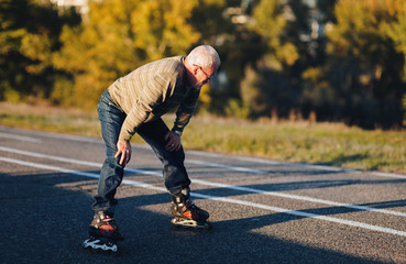 The man on the rollers is tired and resting. Active retiree. Sports activities in old age. Copy space.