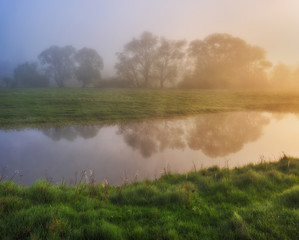 spring morning valley of the picturesque river. foggy dawn