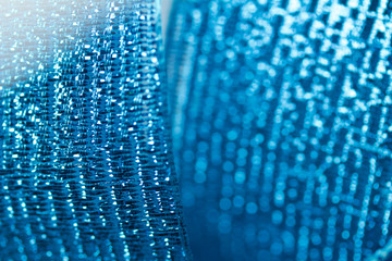 Vibrant blue metallic ribbon macro abstract background with bokeh