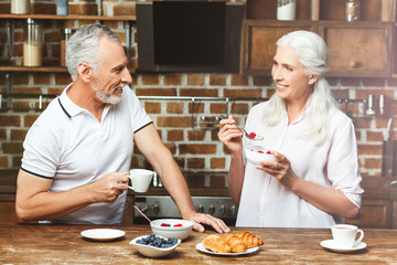 woman looking at her husband drinking coffee