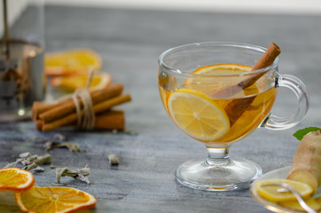 A cup of herbal tea with lemon and cinnamon