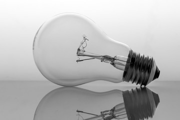 Old bulb filament isolated backlit on white background, conceptual image