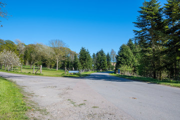 Small Danish countryside road with a sign showing the way to Liselund palace