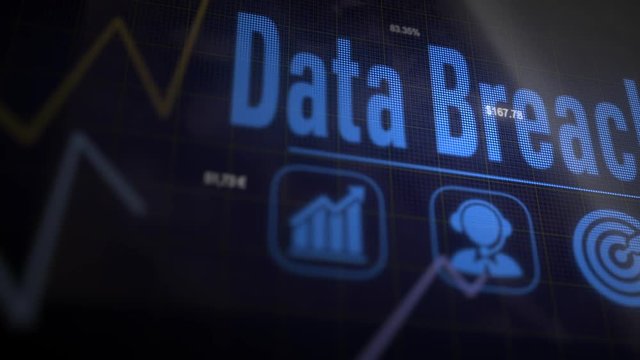 Data Breach business concept on a flashing computer monitor with moving graphs and data.