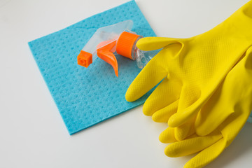 Woman hands with cleaning equipment on white background