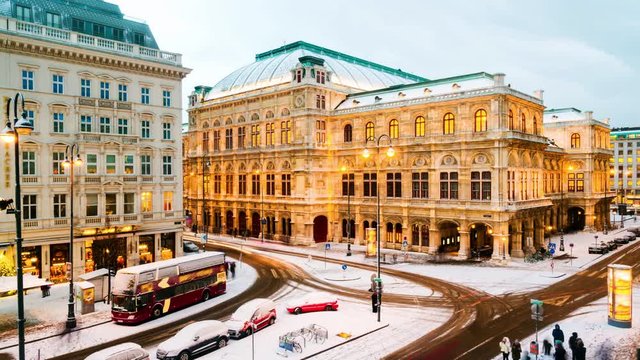 Vienna, Austria. View of State Opera in Vienna, Austria during the snowy evening in winter. Cloudy sky, time-lapse with car traffic