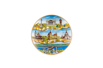 ceramic souvenir toy in the form of plate with beautiful color painting on isolated white background reflecting the national Russian culture with the inscription in Russian: