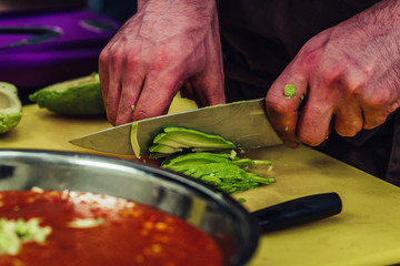 Male Chef Slicing Avocado for Wedding Meal - Kitchen Set with Isolated Action, Only Chef`s Hands