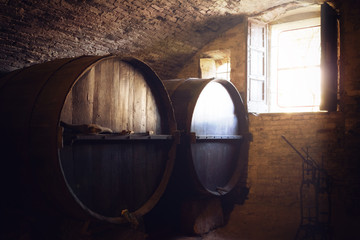 historic wine cellar in Langhe (Piedmont, Italy) with many slavonian oak barrels for the aging of red wine - obrazy, fototapety, plakaty