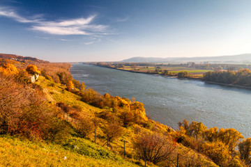 Danube river flowing through the landscape in autumn colors.
