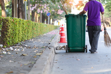 Cleaning worker sweeping garbage on the road.