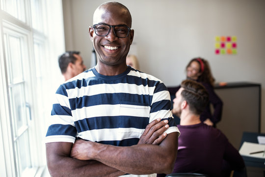 African designer smiling confidently after an office meeting