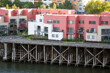 Fototapeta na wymiar Three-story apartments on wooden stilts on the banks of the Willamette River in Portland