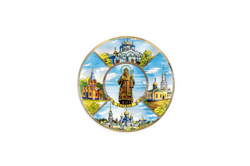 Obraz na płótnie Canvas ceramic souvenir toy in the form of plate with color painting on isolated white background reflecting the national Russian culture with the inscription in Russian: the name of the city of Saratov