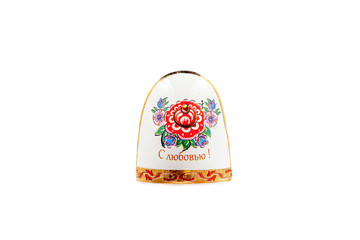 ceramic souvenir toy in the form of bell with beautiful color painting on isolated white background reflecting the national Russian culture with the inscription in Russian: With love