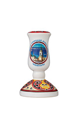 ceramic souvenir toy in the form of candlestick with color painting on isolated white background reflecting the national Russian culture with the inscription in Russian: Holy Trinity Monastery