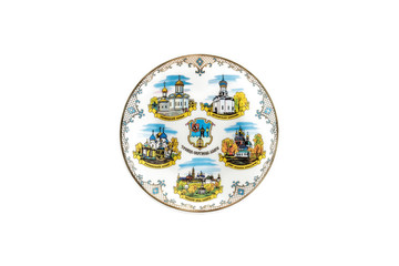 ceramic souvenir toy in the form of plate with beautiful color painting on isolated white background reflecting the national Russian culture with the inscription in Russian: Trinity Sergius Lavra