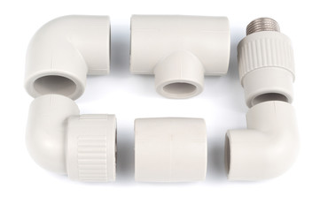 Plastic fittings for polypropylene pipes on a white background