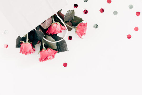 Flowers Composition. Tender Pink Rose In White Paper Bag. Valentine's Day. Birthday, Happy Women's Day. Flat Lay, Top View, Copy Space 