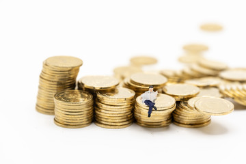 Miniature people: business man making decision on coins stacks, success, dealing, greeting and partner concept.