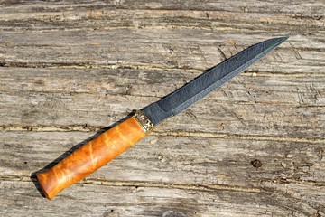 hunting knives on an old log
